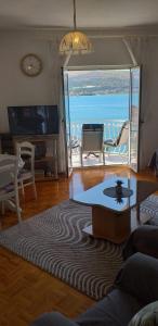 a living room with a view of the ocean at Apartment Matej in Trogir
