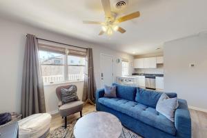 a living room with a blue couch and a kitchen at Sonesta 203 in Ocean City +8 photos