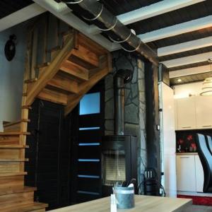 a kitchen with a black door and a stove at Domki u Biesiady in Lesko