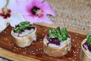 three pieces of food on a cutting board with flowers at 7Piedras in Minca