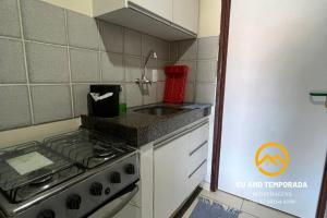 a kitchen with a stove and a sink at @euamotemporada Cumaru APT 207 - 100m da Praia in Marechal Deodoro