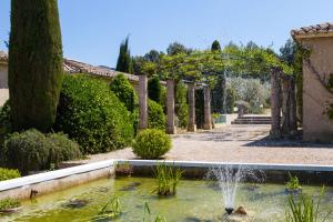 un jardin avec une fontaine au milieu d'un étang dans l'établissement SUPER COZY MAZET 5mn FROM HEART OF SAINT REMY, à Saint-Rémy-de-Provence