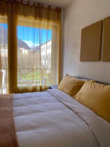 A bed or beds in a room at Valtellina Vacanze