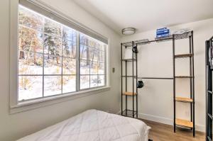 a bedroom with a bed and a window at The Cottages Sweet Skiiers Escape On The Resort! in Beaver