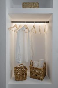 zwei Körbe und Handtücher auf einem Regal im Schrank in der Unterkunft Maison Kalogiannis in Patitiri
