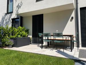 a patio with a table and chairs on it at Schubert am Wörthersee in Krumpendorf am Wörthersee