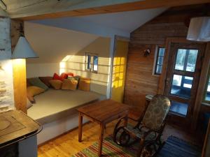 a room with a bed and a table and a chair at Puise saunahouse and outdoor kitchen at Matsalu Nature Park in Puise