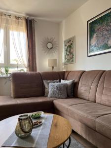 a living room with a brown couch and a table at Apartment in Zadar in Zadar