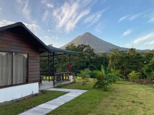 a house with a view of a mountain in the background at Hotel Campo Verde in Fortuna