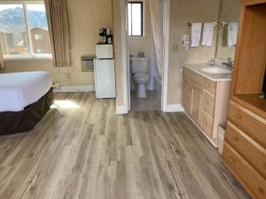 a bathroom with a bed and a toilet and a sink at Blue Door Inn in Estes Park