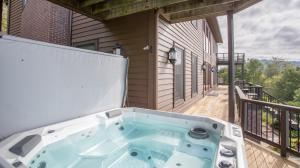 a hot tub on the back porch of a house at The Retreat at Mountain Meadows in Banner Elk