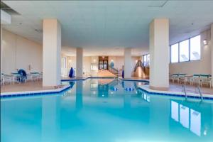 a swimming pool with blue water in a building at Marigot Beach 1207 in Ocean City
