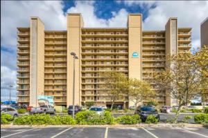 a large building with cars parked in a parking lot at Marigot Beach 1207 in Ocean City