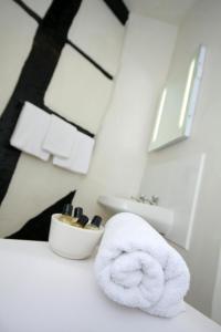 a bathroom with a white towel and a sink at Crown Hotel in Nantwich