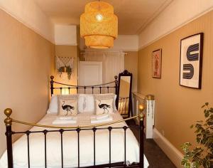 1 dormitorio con 1 cama con 2 gatos en las almohadas en Stunning seafront apartment, en Brighton & Hove