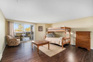 a bedroom with a bed and a table and a chair at South Beach 26 in Glen Arbor