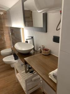 a bathroom with two sinks and two toilets at Ely's Home in Bari