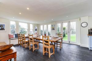 a kitchen and dining room with a table and chairs at Downedge in Brading