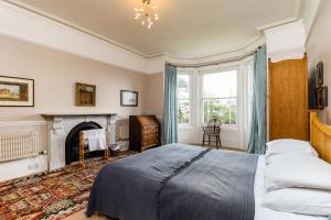 a bedroom with a bed and a fireplace at Downedge in Brading