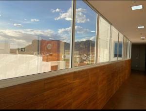 a large window in a room with a view of a city at EMA HOTEL in Serra Talhada