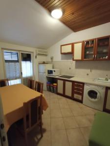 a kitchen with a table and a counter top at Apartments Timi in Poreč