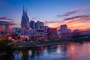 a city skyline at sunset with a river and a city at Kimpton Aertson Hotel by IHG in Nashville