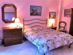 a bedroom with a bed and a dresser and a mirror at Agriturismo Campo Al Sole in Castell’Anselmo +23 photos