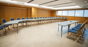 a conference room with a long table and chairs at Doanesia Premium Hotel & Spa in Tirana