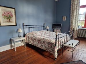 a bedroom with a bed and a tv and a chair at Wohnung in Satow mit Garten in Gerdshagen +27 photos