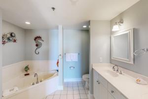 a bathroom with a tub and a sink and a toilet at Waterscape B603 in Fort Walton Beach