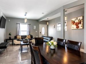 a living room with a wooden table and chairs at The Prospect Point Penthouse- Yard & Parking, Minutes From Falls & Casino by Niagara Hospitality in Niagara Falls