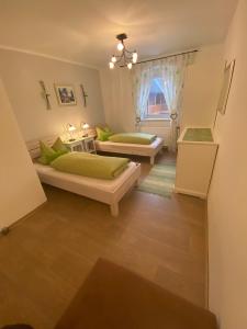 a bedroom with two beds and a window at Familienbauernhof Strassbauer in Steinakirchen am Forst