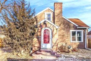 une maison en briques avec une porte rouge dans l'établissement Comfortable & Convenient Home, Sleeps 15, à Sioux Falls