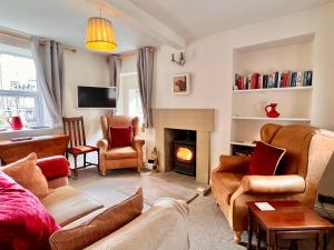 a living room with a couch and a fire place at Gate Cottage in Matlock