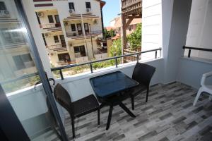 a balcony with a table and chairs and a view of a city at Piri Reis Butik Hotel in Marmara
