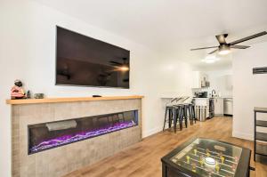 a living room with a fireplace and a flat screen tv at The Cottages Ski-InandSki-Out Condo at Eagle Point! in Beaver