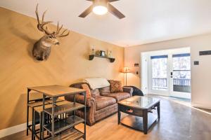 a living room with a couch and a deer head on the wall at The Cottages Ski-InandSki-Out Condo at Eagle Point! in Beaver