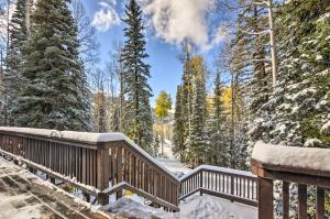a wooden bridge in a snowy forest with trees at The Cottages Ski-InandSki-Out Condo at Eagle Point! in Beaver