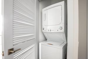 a white washer and dryer in a white refrigerator at Loop 1BR w Deck Gym WD nr W Loop the L CHI-220 in Chicago +24 photos