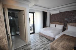 A bed or beds in a room at Piri Reis Butik Hotel