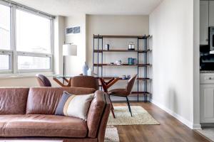 a living room with a couch and a table at River N 2BR wGym Deck Pool nr Mag Mile CHI-133 in Chicago