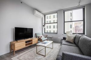a living room with a couch and a flat screen tv at Loop 1BR wGym Roofdeck WD nr W Loop the L CHI-200 in Chicago