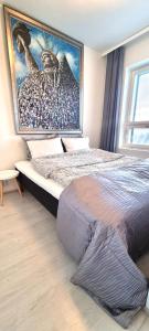 a bedroom with two beds and a large painting on the wall at MM City Apartment Next to Arena in Tampere