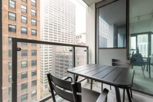 a table and chairs in a room with a large window at Loop 1BR w Gym Pool WD nr Financial District CHI-222 in Chicago