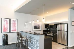 a kitchen with white walls and a black counter top at Loop 1BR w Gym Pool WD nr Financial District CHI-229 in Chicago