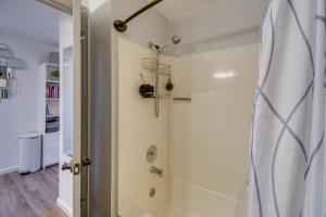 a bathroom with a shower with a shower curtain at Ocean Shores Condo Walk to the Beach! in Ocean Shores