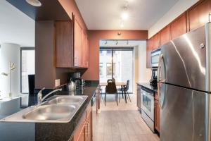 a kitchen with a stainless steel refrigerator and a table at Loop 1BR w Gym Pool nr Financial District CHI-233 in Chicago