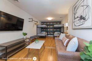 a living room with a couch and a table at West Broadway Quarters by Thatch in Boston