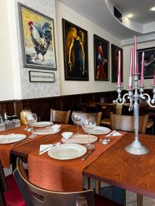 a dining room with a wooden table with pink candles at Hotel CENTRAL Balchik in Balchik