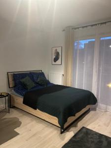 Łóżko lub łóżka w pokoju w obiekcie Harmonia Apartments
